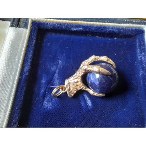 373 - Interesting hallmarked 9 ct gold and lapis ball and claw charm in a Richard Ogden presentation box o... 