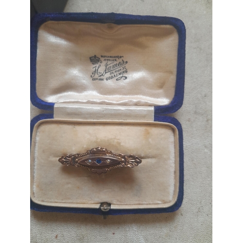 384 - Clearly hallmarked 9 ct gold mourning brooch set with single sapphire and pearls in presentation box... 