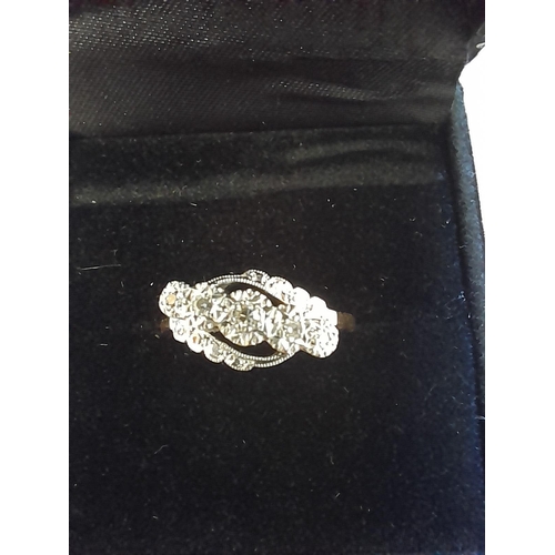 395 - 18 ct gold ring platinum set with five graduated diamonds with a run of three smaller size diamonds ... 