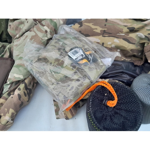 105 - Some new old stock, camping sets, Army fatigues and smock, Berghaus rucksack etc.