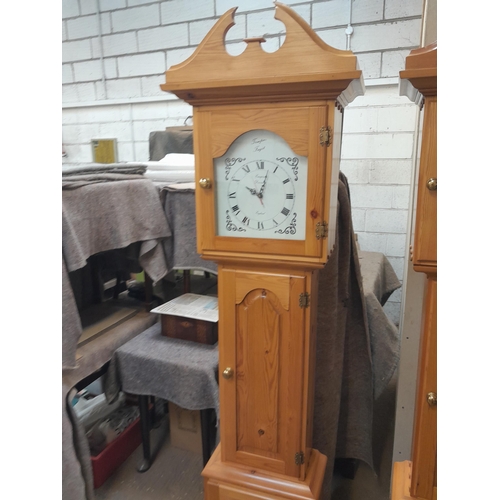 49 - Modern pine longcase clock with quartz movement opening to reveal cabinets in the body 55 cms x 28 c... 