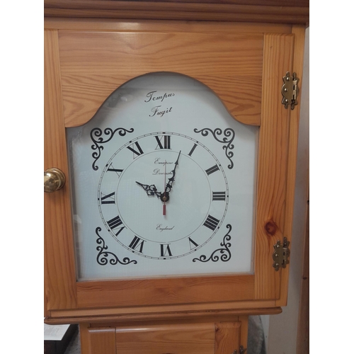 49 - Modern pine longcase clock with quartz movement opening to reveal cabinets in the body 55 cms x 28 c... 