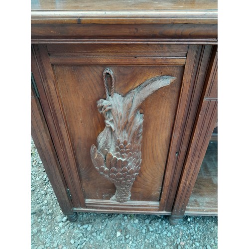 137 - Victorian heavily carved oak sideboard with well carved applied models of game and fish, note this l... 