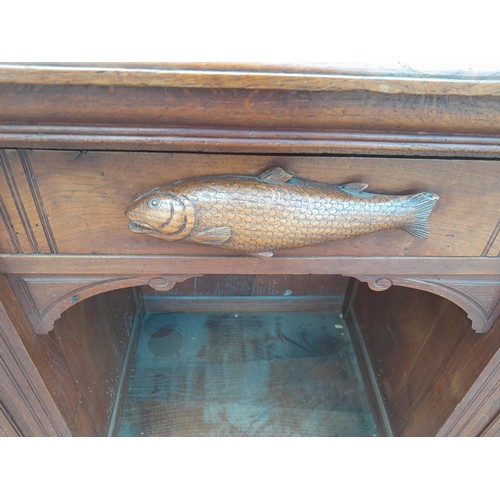 137 - Victorian heavily carved oak sideboard with well carved applied models of game and fish, note this l... 