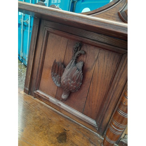 137 - Victorian heavily carved oak sideboard with well carved applied models of game and fish, note this l... 