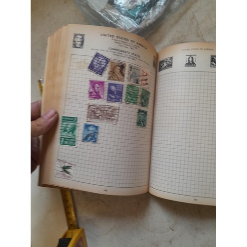 306 - Sparsely filled album of used stamps of the world and loose mint and used stamps