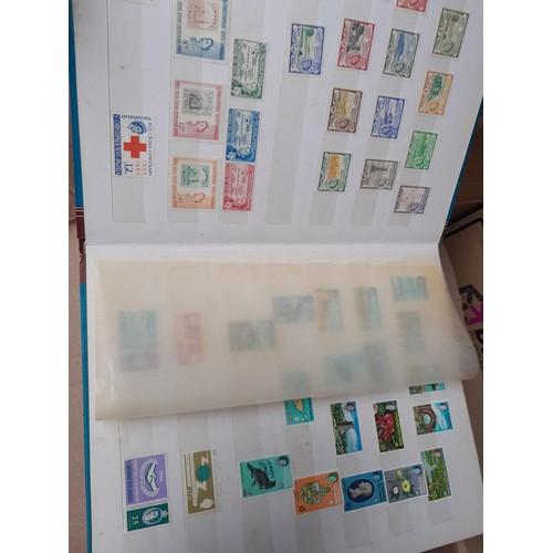 4 - Assorted stamp stock books and loose pages with mint and used QEII era Commonwealth, badly stored wi... 