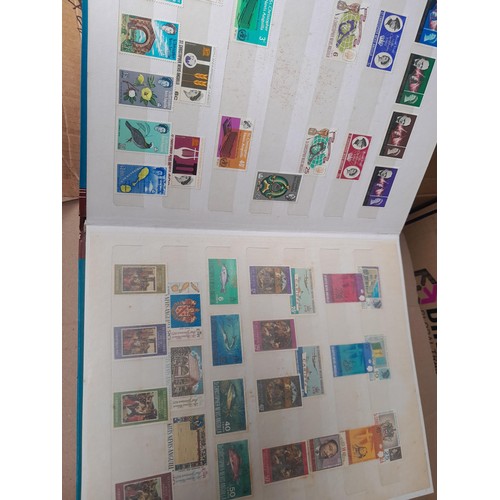 4 - Assorted stamp stock books and loose pages with mint and used QEII era Commonwealth, badly stored wi... 