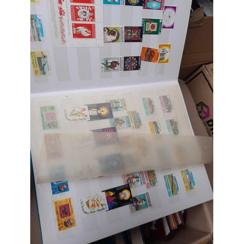 4 - Assorted stamp stock books and loose pages with mint and used QEII era Commonwealth, badly stored wi... 