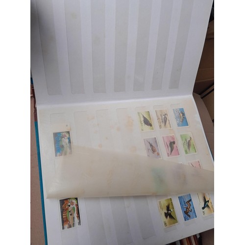 4 - Assorted stamp stock books and loose pages with mint and used QEII era Commonwealth, badly stored wi... 