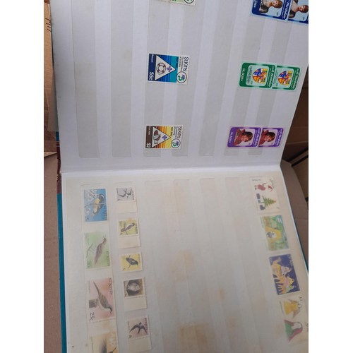 4 - Assorted stamp stock books and loose pages with mint and used QEII era Commonwealth, badly stored wi... 