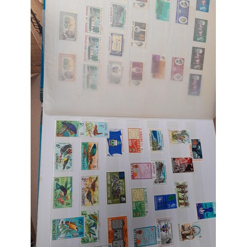 4 - Assorted stamp stock books and loose pages with mint and used QEII era Commonwealth, badly stored wi... 