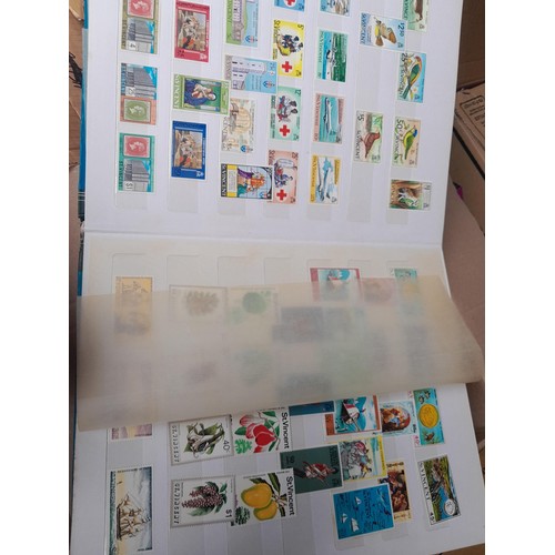 4 - Assorted stamp stock books and loose pages with mint and used QEII era Commonwealth, badly stored wi... 