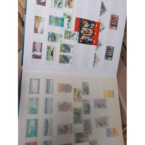 4 - Assorted stamp stock books and loose pages with mint and used QEII era Commonwealth, badly stored wi... 