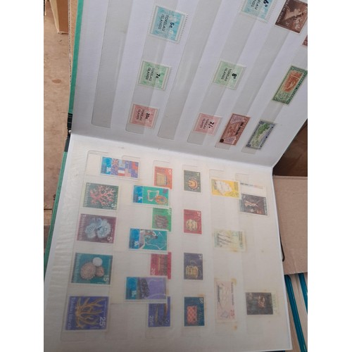 4 - Assorted stamp stock books and loose pages with mint and used QEII era Commonwealth, badly stored wi... 