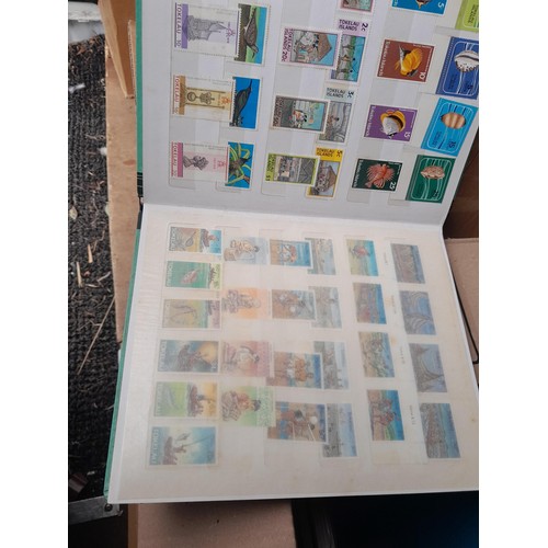 4 - Assorted stamp stock books and loose pages with mint and used QEII era Commonwealth, badly stored wi... 