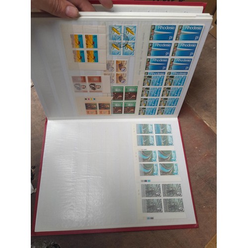 5 - Stamps of Rhodesia in four volumes, includes modern unmounted mint and earlier used