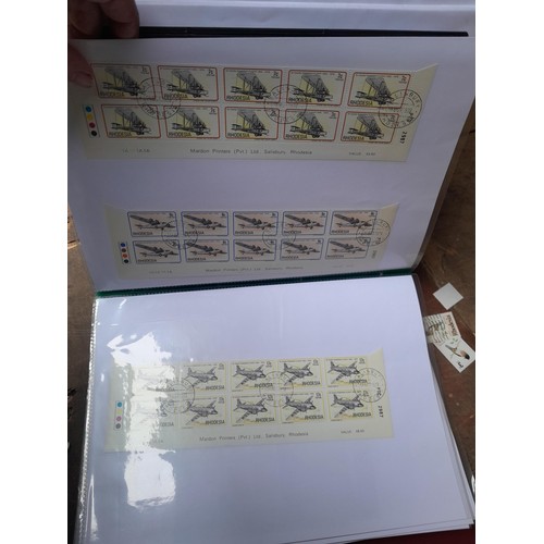 5 - Stamps of Rhodesia in four volumes, includes modern unmounted mint and earlier used