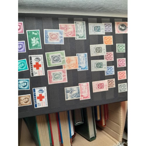 15 - Assorted stamp stock books and loose pages with mint and used QEII era Commonwealth, badly stored wi... 