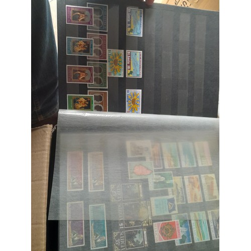 15 - Assorted stamp stock books and loose pages with mint and used QEII era Commonwealth, badly stored wi... 