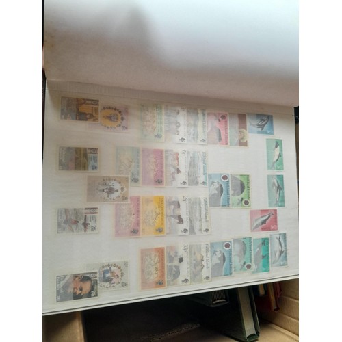 15 - Assorted stamp stock books and loose pages with mint and used QEII era Commonwealth, badly stored wi... 