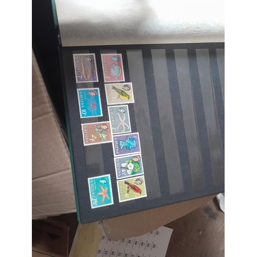 15 - Assorted stamp stock books and loose pages with mint and used QEII era Commonwealth, badly stored wi... 