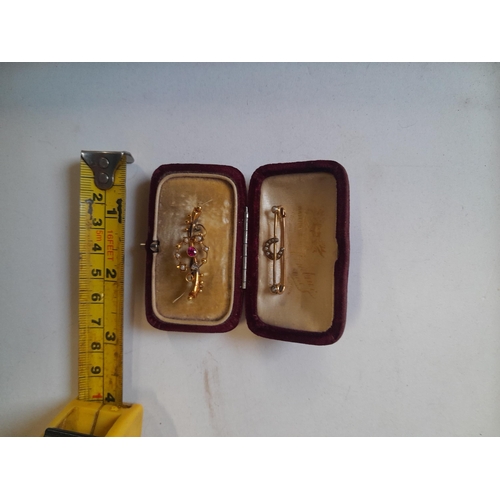 34 - 2 x 9 ct gold bar brooches , one set with horseshoe and pearls the other set with ruby and pearls on... 