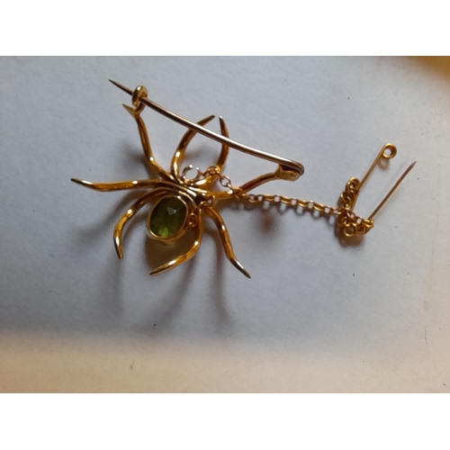 36 - Very pretty brooch unmarked but tested as 9 ct modelled as a spider set with single peridot and pear... 