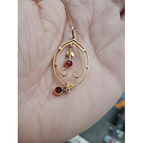 40 - Unmarked but tested 9 ct gold pendant on chain set with 2 x rubies and single pearl 3.3 g