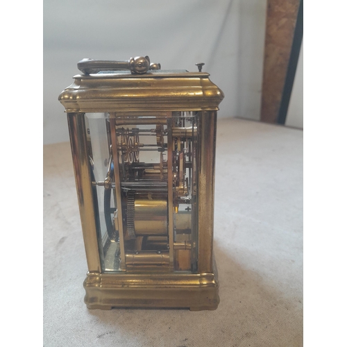 122 - Early 20th century French striking mantle / carriage clock in brass and bevelled glass case with key... 