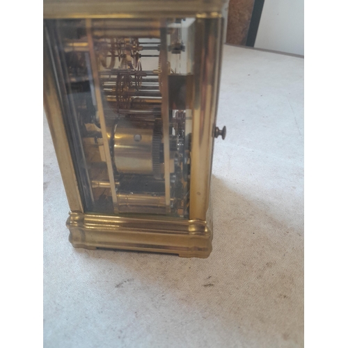 122 - Early 20th century French striking mantle / carriage clock in brass and bevelled glass case with key... 