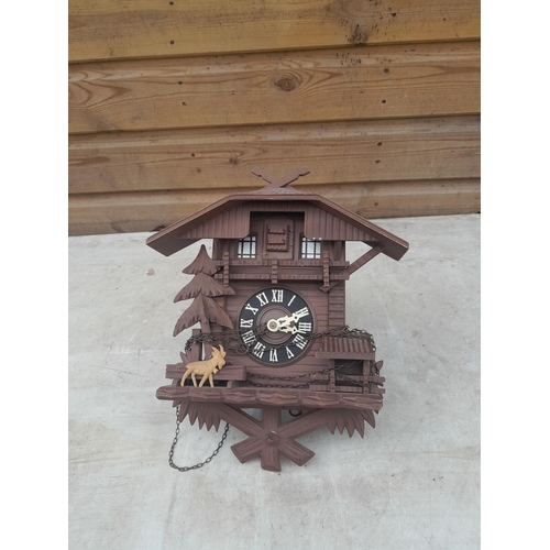 470 - Cuckoo clock with pine cone weights and spare weights