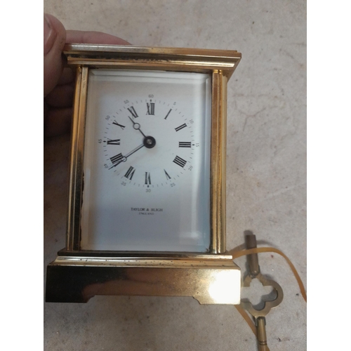 130 - Vintage brass and bevelled glass carriage clock retailed through Taylor and Bligh