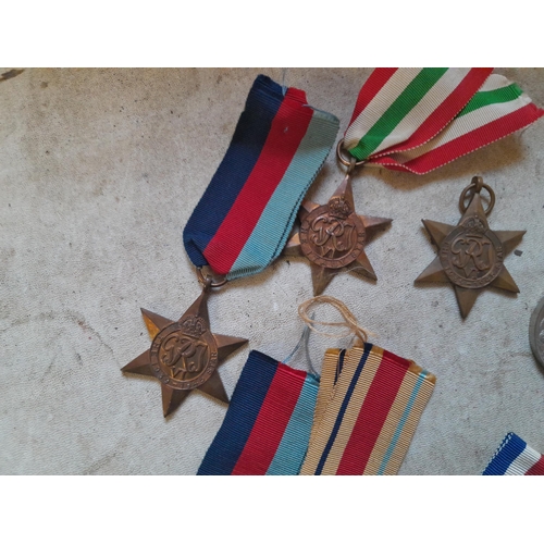 236 - Random array of World War II medals some with ribbons, no associated paperwork