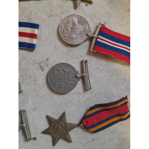 236 - Random array of World War II medals some with ribbons, no associated paperwork