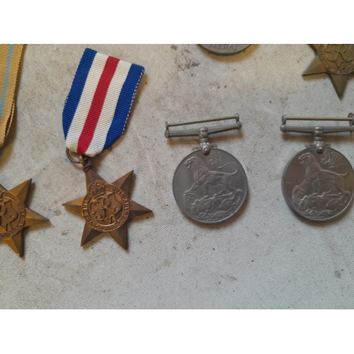 236 - Random array of World War II medals some with ribbons, no associated paperwork