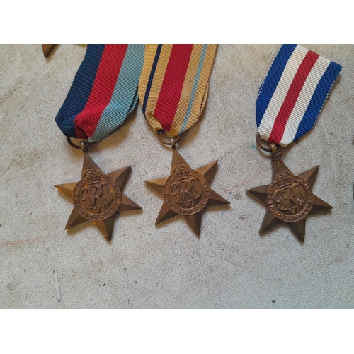 236 - Random array of World War II medals some with ribbons, no associated paperwork