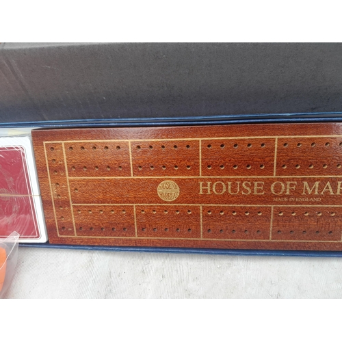 296 - Box of oddments : House of Marbles boxed cribbage board, fishing stool, pump etc.