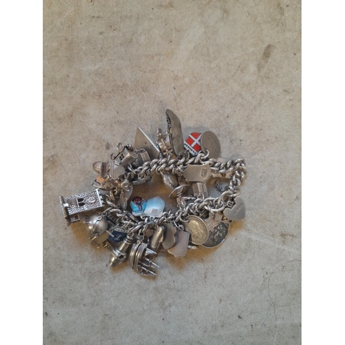 372 - Silver charm bracelet with lots of charms, more interesting charms noticed