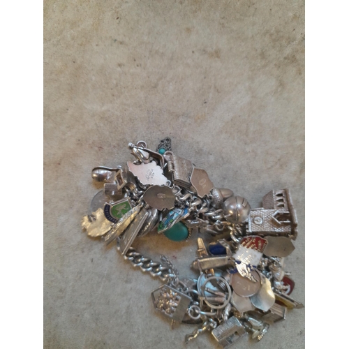 372 - Silver charm bracelet with lots of charms, more interesting charms noticed