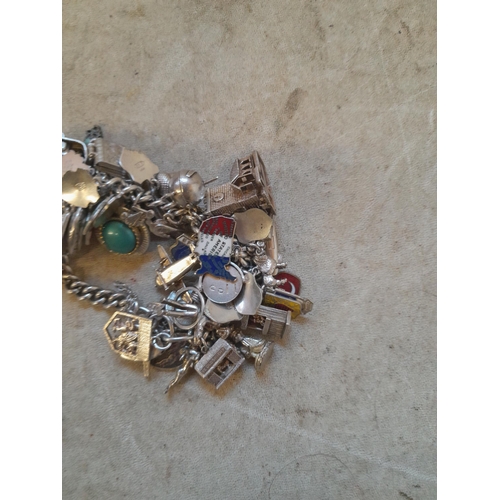 372 - Silver charm bracelet with lots of charms, more interesting charms noticed