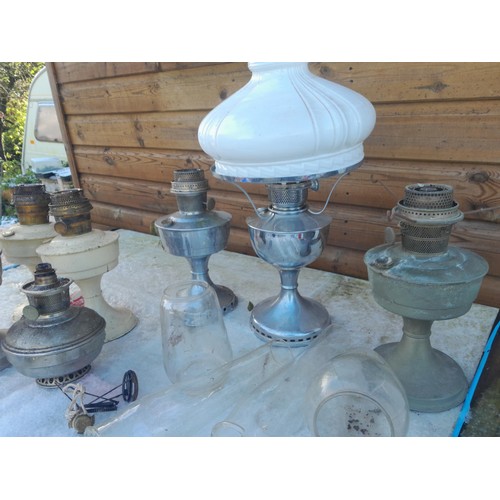 11 - Collection of paraffin lamps some spares etc.