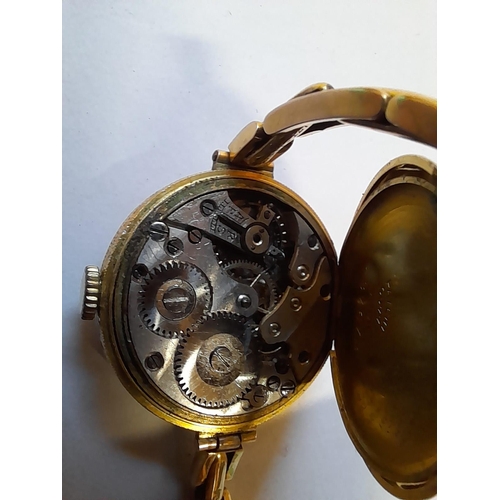 87 - Vintage ladies wristwatch with 12 ct gold back and articulated 9 ct gold strap  gross weight 25 g