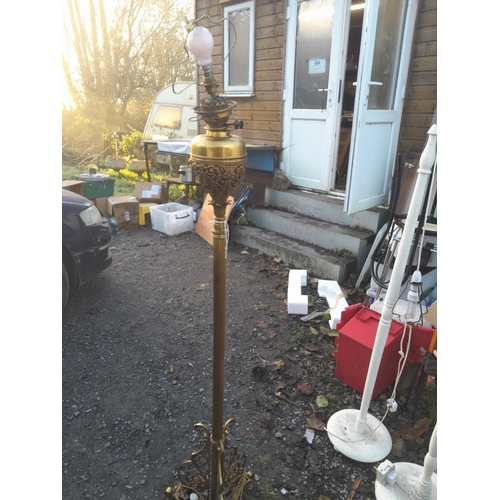 199 - Edwardian brass  paraffin standard lamp on pierced legs converted to electric (neds re wire)