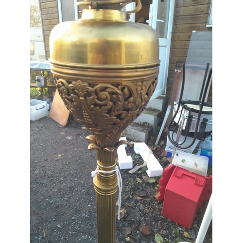 199 - Edwardian brass  paraffin standard lamp on pierced legs converted to electric (neds re wire)