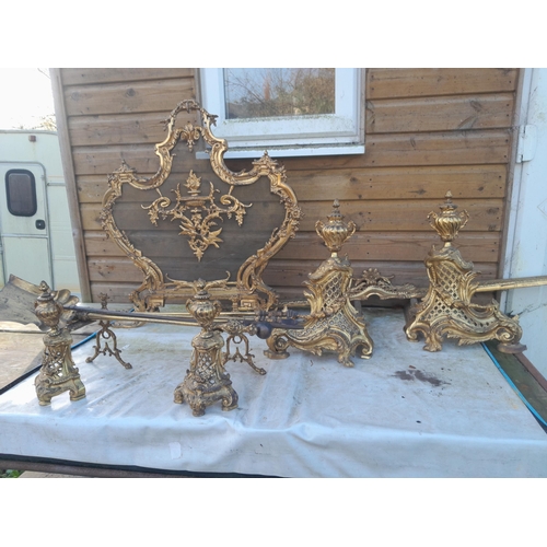 223 - An Elegant late 19th century French gilded metal fireside set including : Spark guard, kerb and tool... 