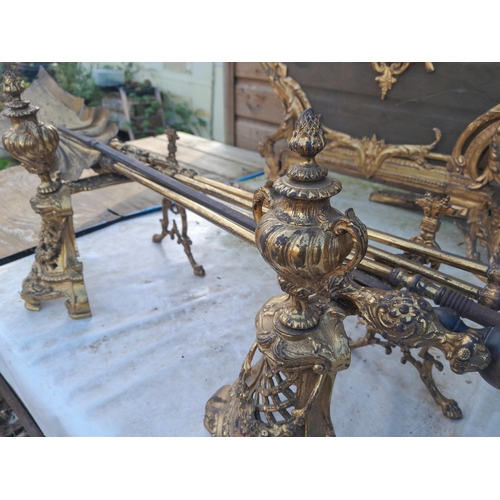 223 - An Elegant late 19th century French gilded metal fireside set including : Spark guard, kerb and tool... 