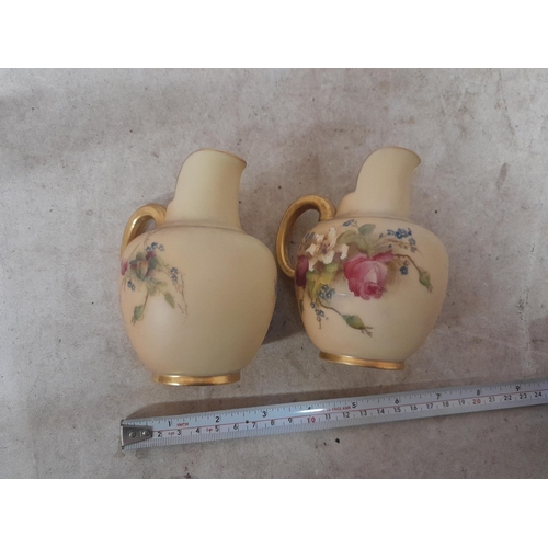 286 - Pair of Royal Worcester blush ivory porcelain small size jugs with floral decoration in good order