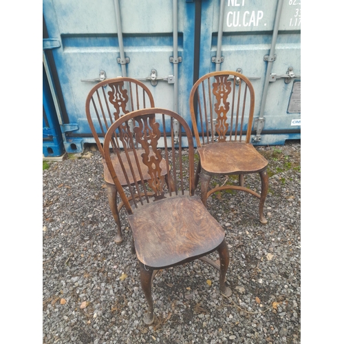 557 - Set of four crinoline stretcher carved splat and  
 stick back Windsor chairs from the early 20th ce... 