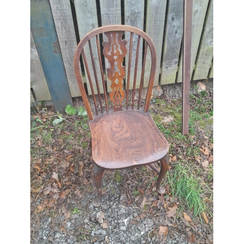 557 - Set of four crinoline stretcher carved splat and  
 stick back Windsor chairs from the early 20th ce... 